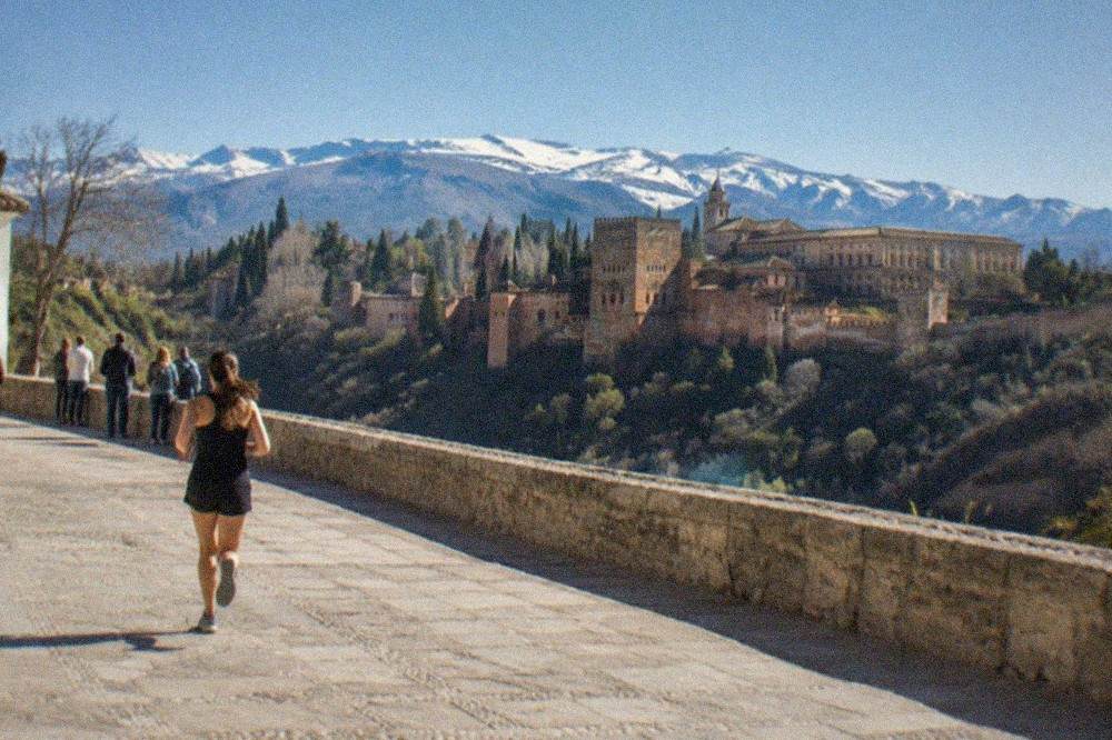Crowds gathered at the Mirador de San Nicolas at dusk watching the illuminated Alhambra across the valley