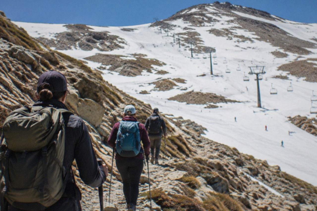 Hikers walking a rocky mountain path high in the Sierra Nevada above Granada