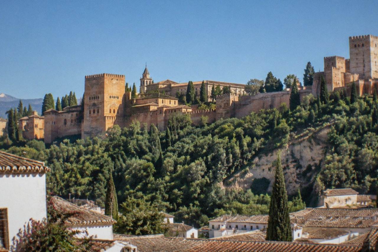 The Alhambra palace complex on its hillside above the red rooftops of Granada