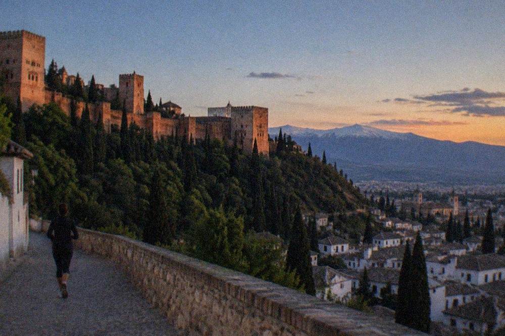 Sunset over the Albaicin rooftops with the Alhambra and Sierra Nevada in the distance