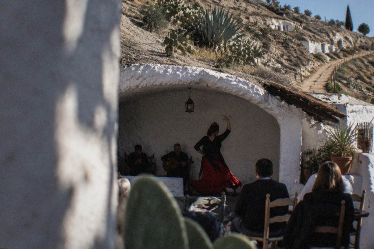 A flamenco dancer performing inside a whitewashed cave venue in the Sacromonte district of Granada