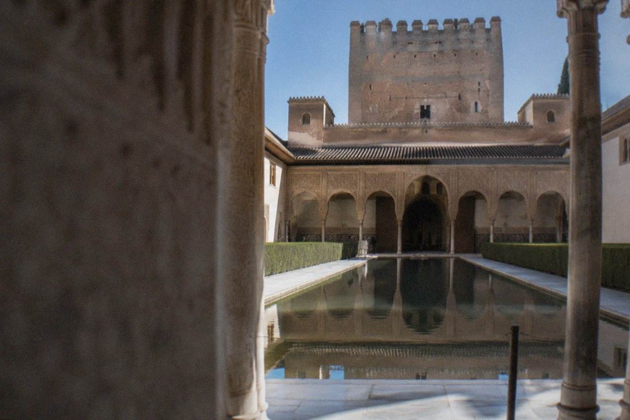 The Court of the Lions in the Nasrid Palaces of the Alhambra under a clear sky