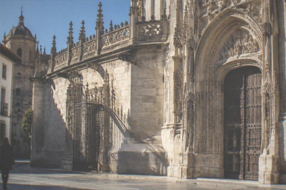 Stone facade of the Royal Chapel in Granada with ornate doors