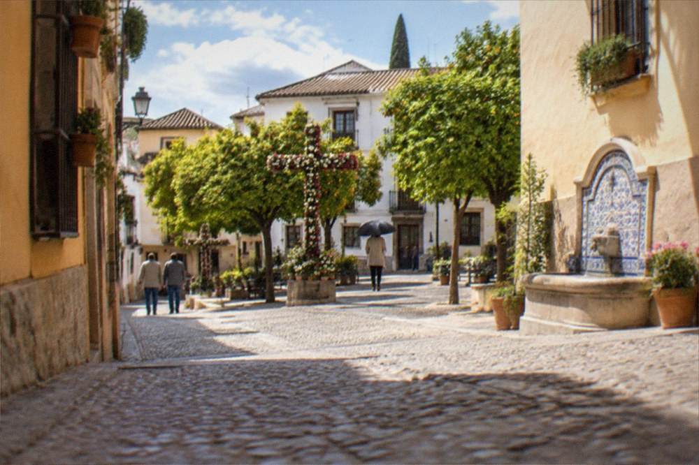 Spring morning in a Realejo square with orange trees and decorated crosses for the May festival