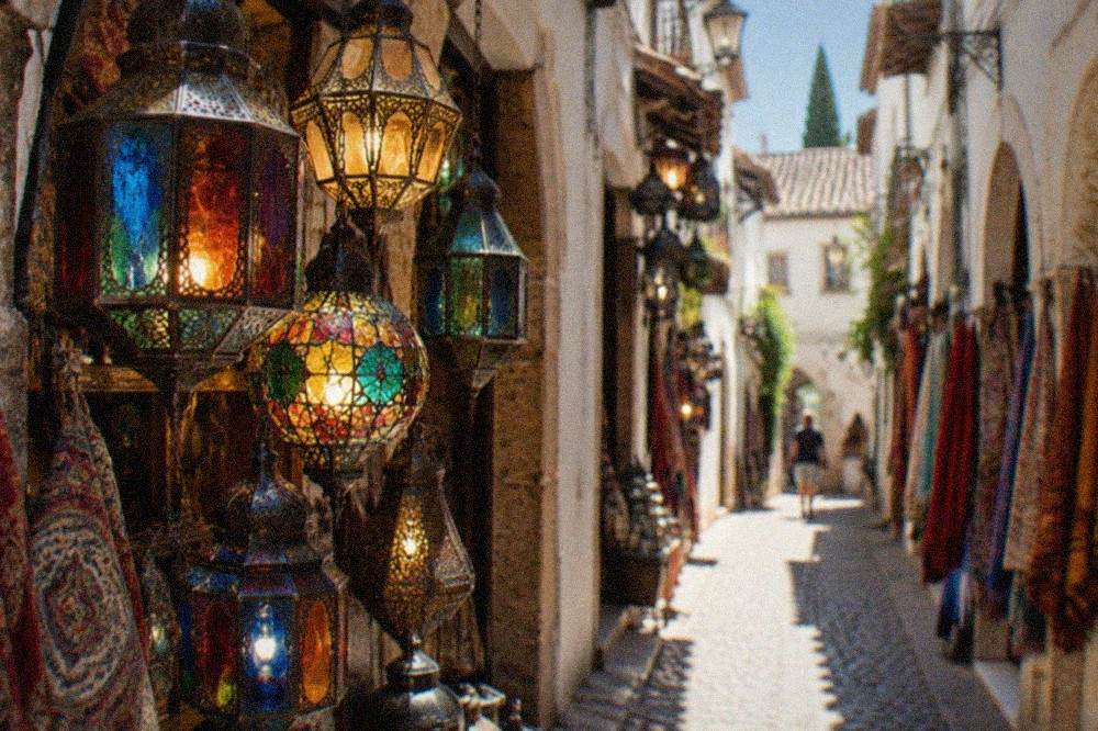 Close view of a shopfront in the Alcaiceria displaying hanging coloured glass lanterns