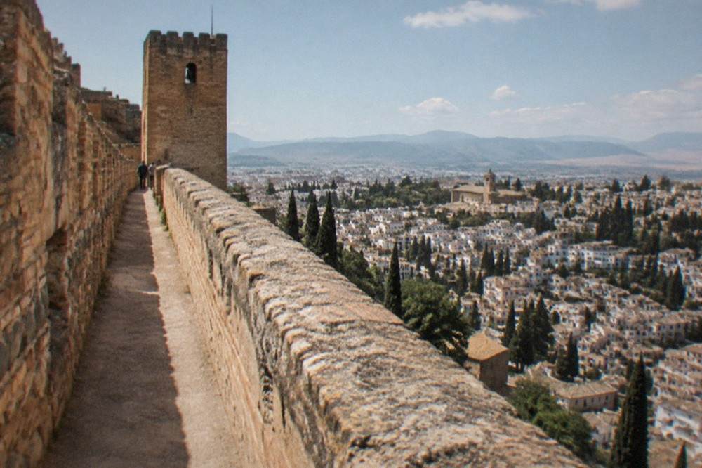 A walkway along the top of the Alcazaba walls with the city of Granada spread out below