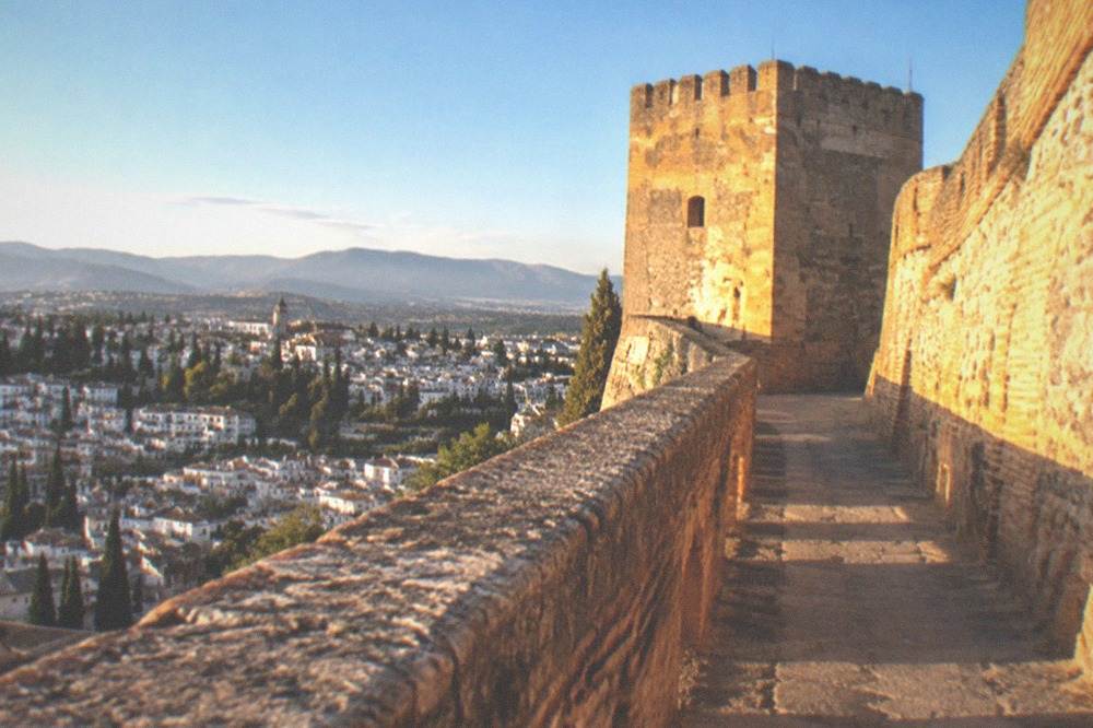Late afternoon sunlight on the fortress walls with long shadows across the stone courtyard