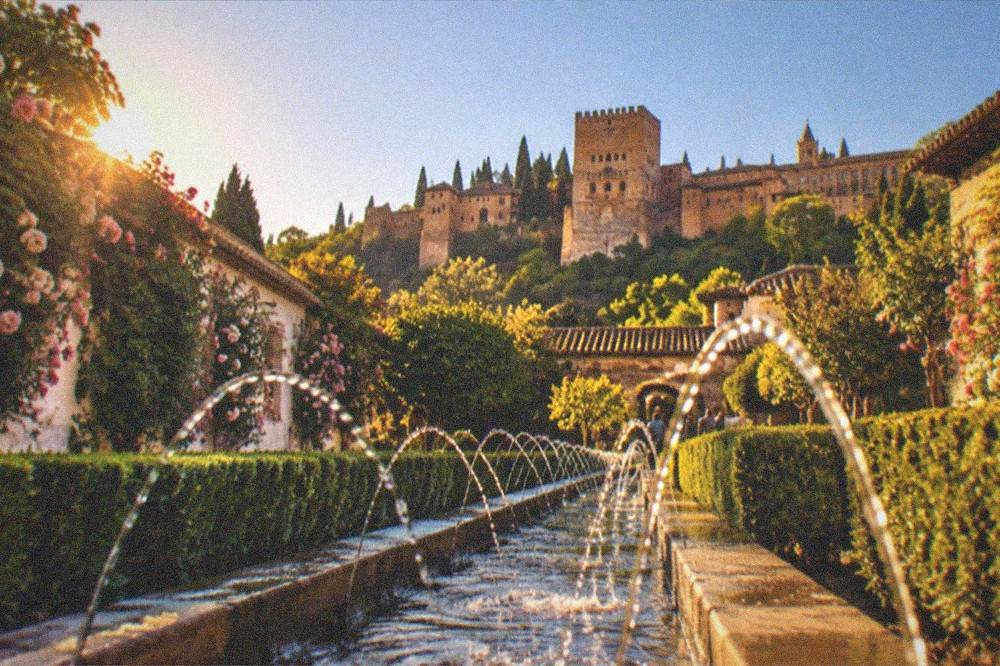The Alhambra and Generalife seen at dusk from a viewpoint across the Darro valley