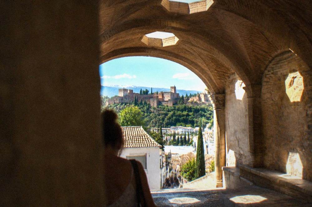 Sunlight passing through small octagonal skylights in a brick vault in Granada