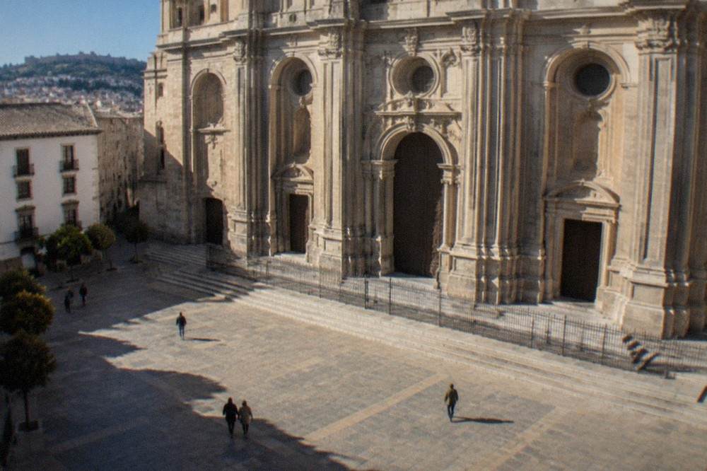 Interior nave of Granada Cathedral with tall columns and stone vaulting