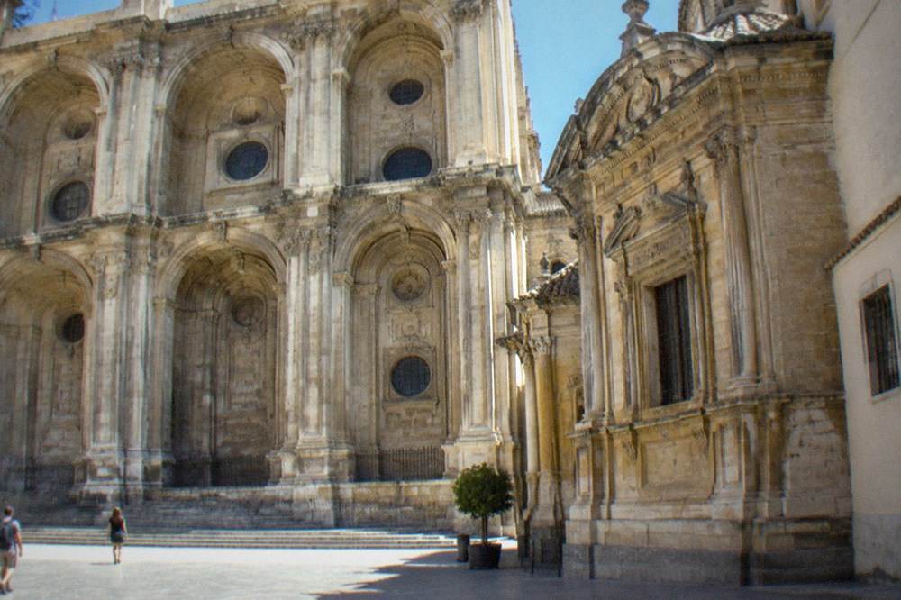 Sunlit side chapel inside Granada Cathedral with ornate stonework