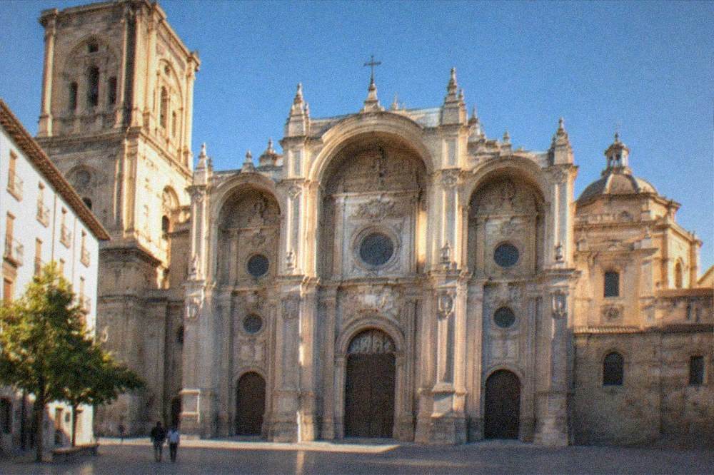 The cathedral facade under a clear blue sky in late afternoon light
