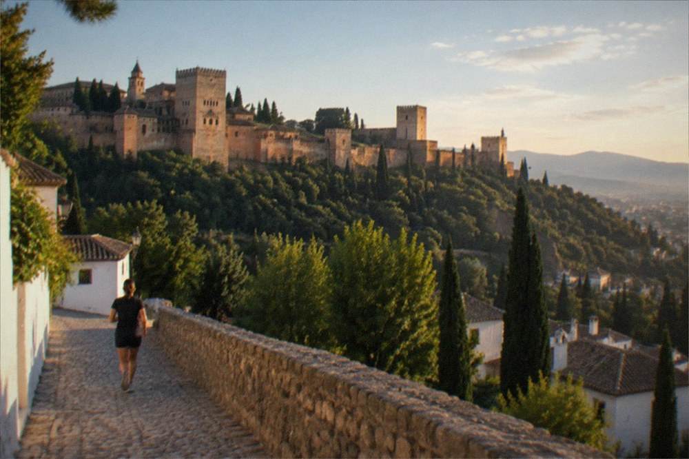 The Alhambra palaces seen from a viewpoint across the valley at sunset
