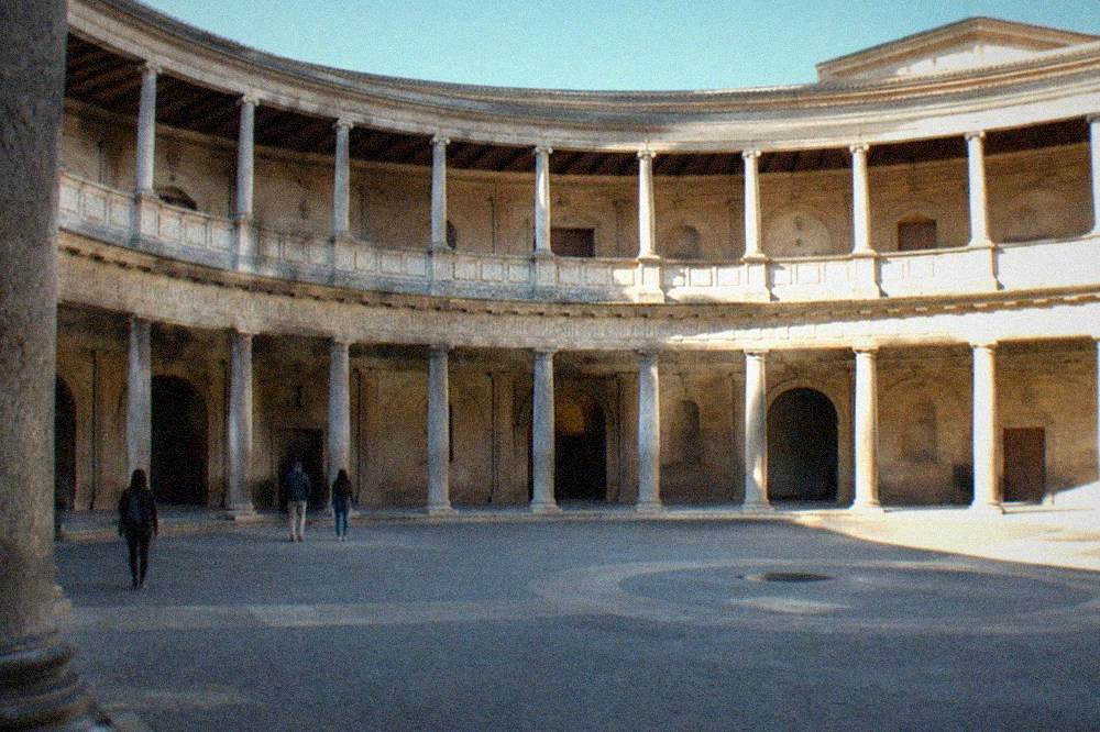 Afternoon sunlight falling across the ring of columns in the circular courtyard