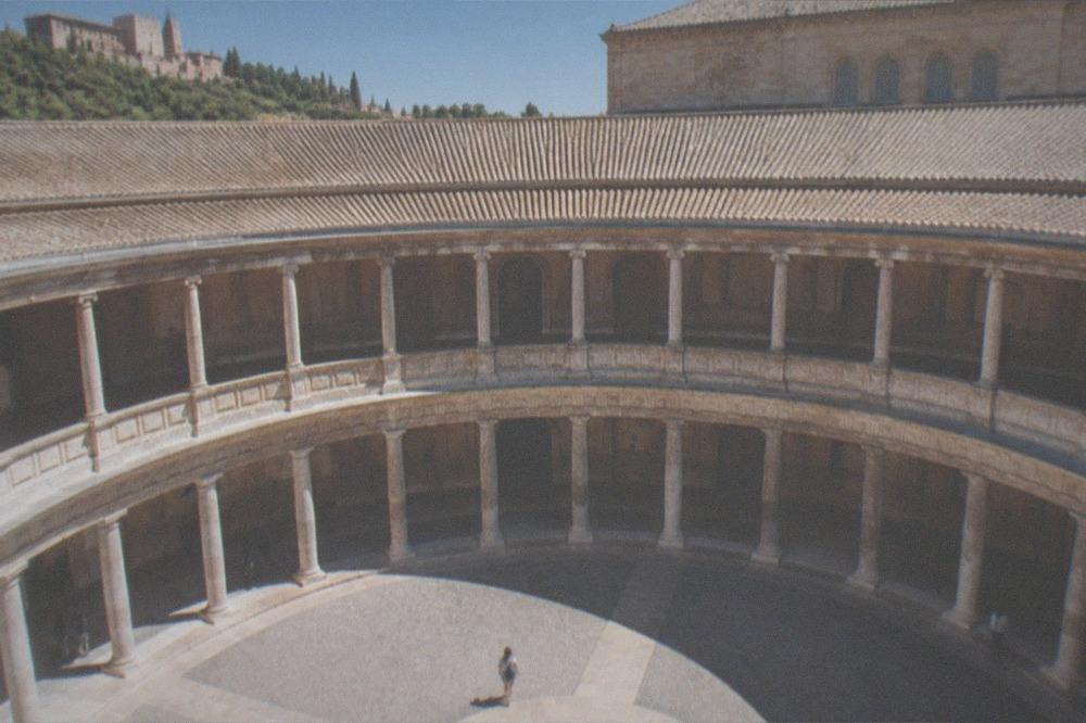 The plain stone facade of the palace contrasted with the ornate Nasrid walls nearby