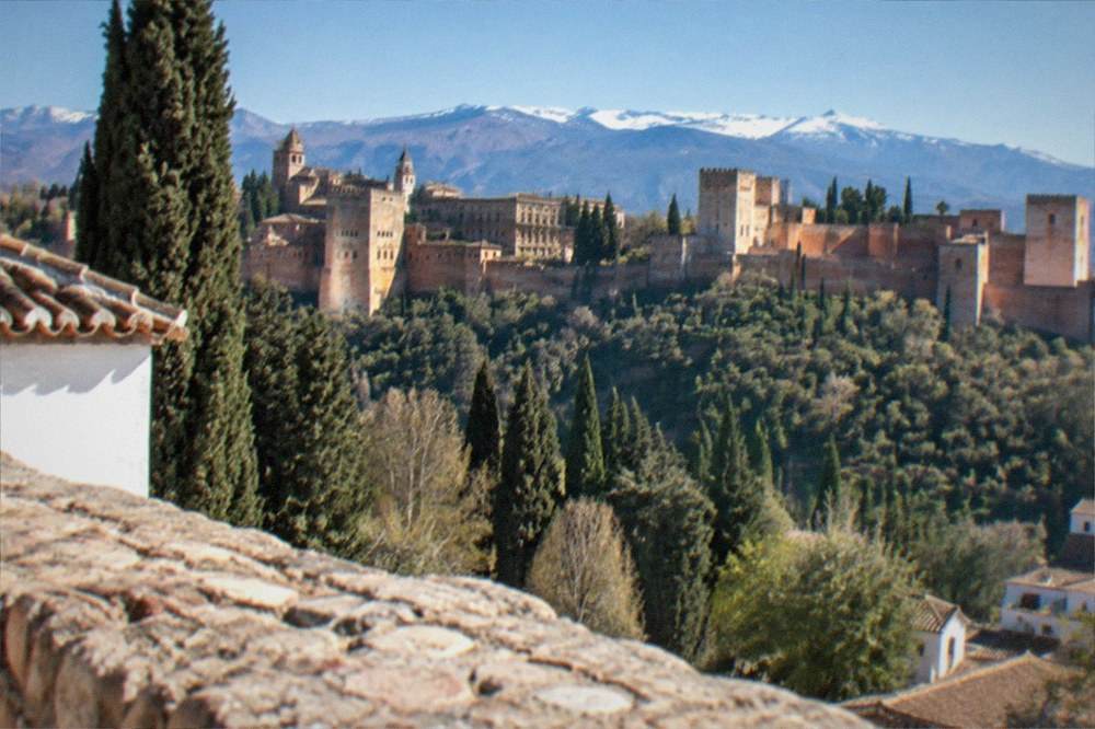 The Alhambra complex seen from a distance with the Sierra Nevada behind