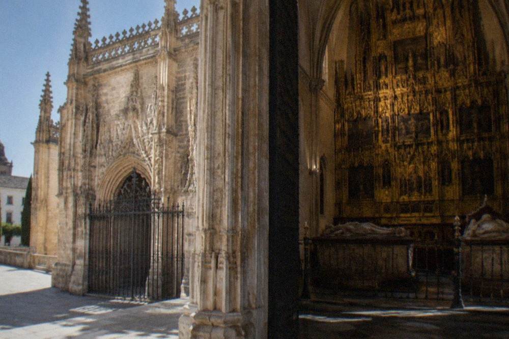 Interior of the Royal Chapel with a gilded Gothic altarpiece and royal tombs