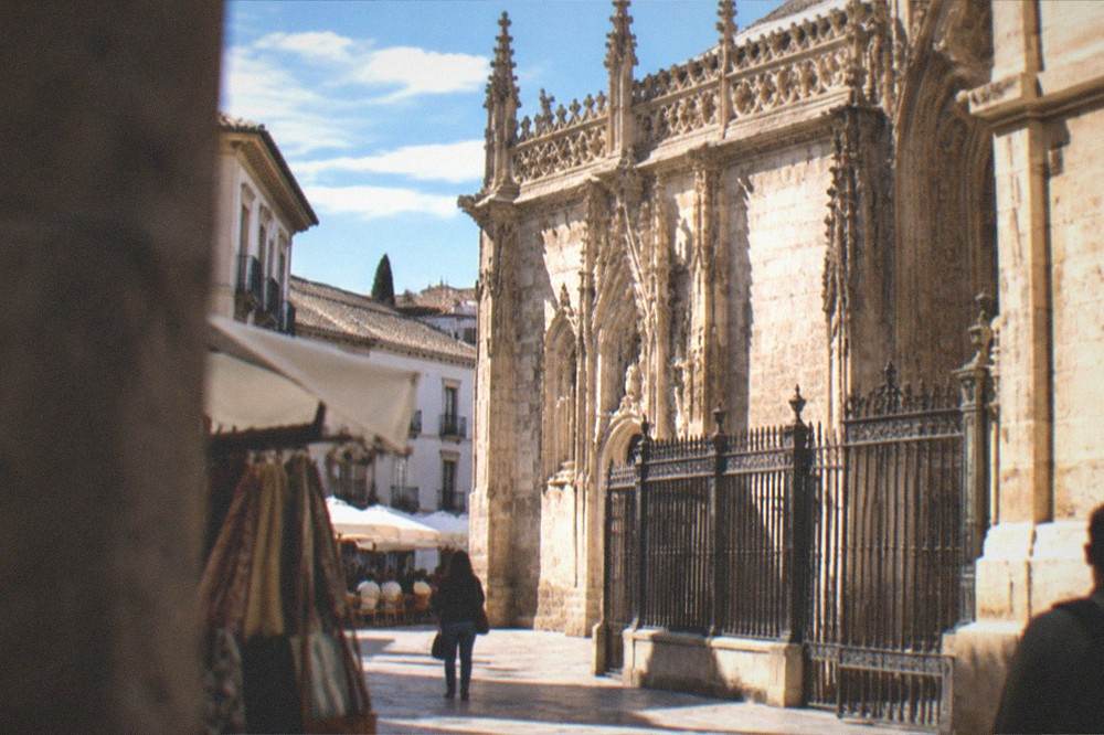 Old town street near the Cathedral with market stalls and cafe tables
