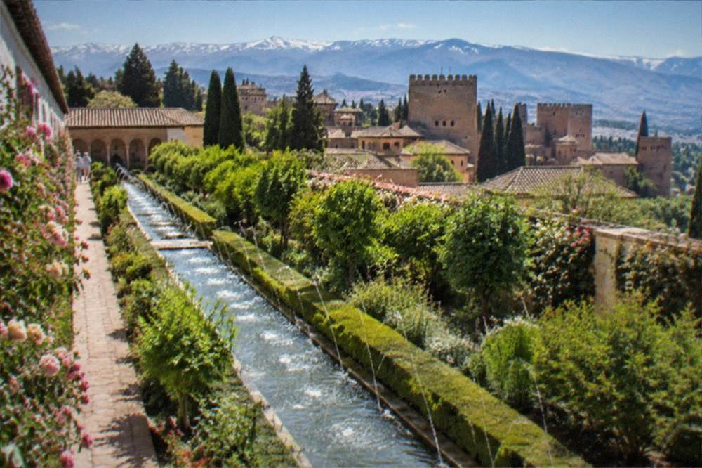 Aerial view of the Alhambra complex with the Generalife gardens and the Sierra Nevada mountains behind