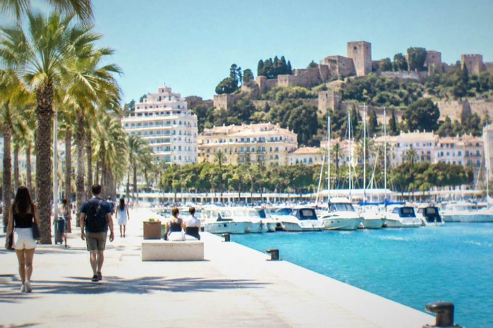 Moorish fortress walls and gardens overlooking a coastal city skyline