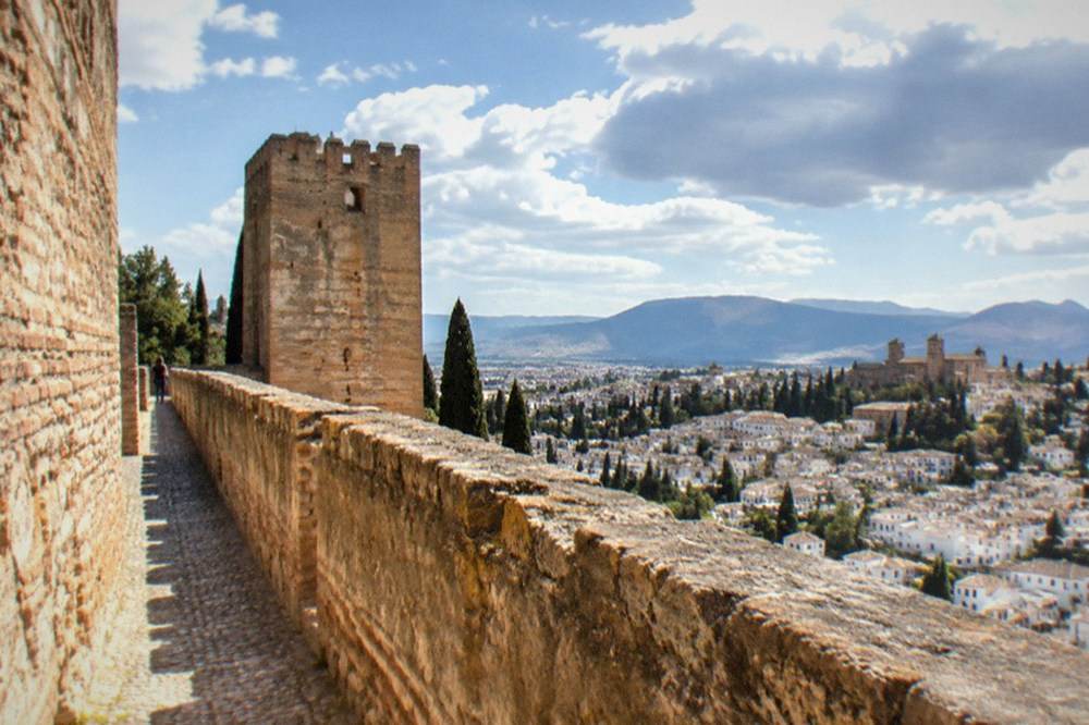 A stone watchtower of the Alcazaba overlooking the rooftops of Granada