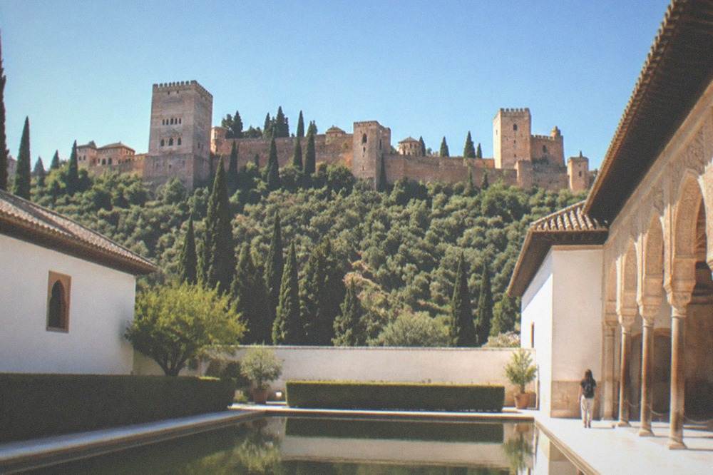 A quiet colonnaded courtyard with a reflecting pool in the Alhambra palaces