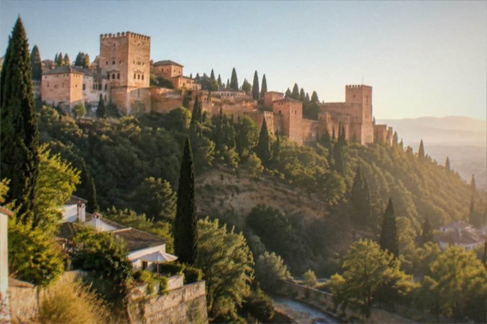 The Alhambra seen at sunset from a viewpoint across the Darro valley
