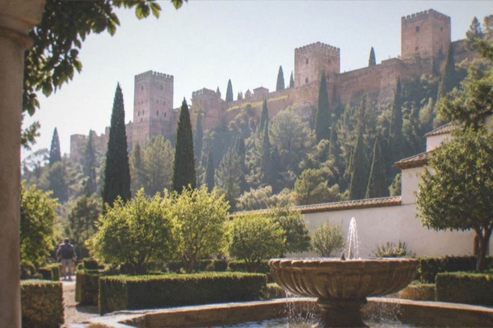 Fountain and trimmed myrtle hedges in a courtyard garden of the Alhambra