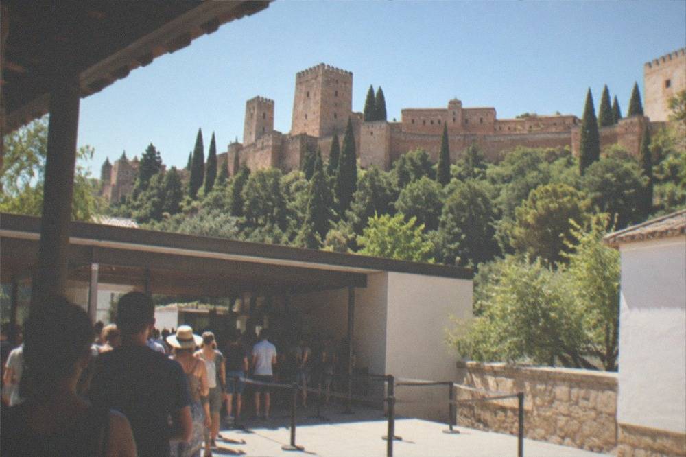 The outdoor ticket pavilion entrance of the Alhambra with visitors queuing