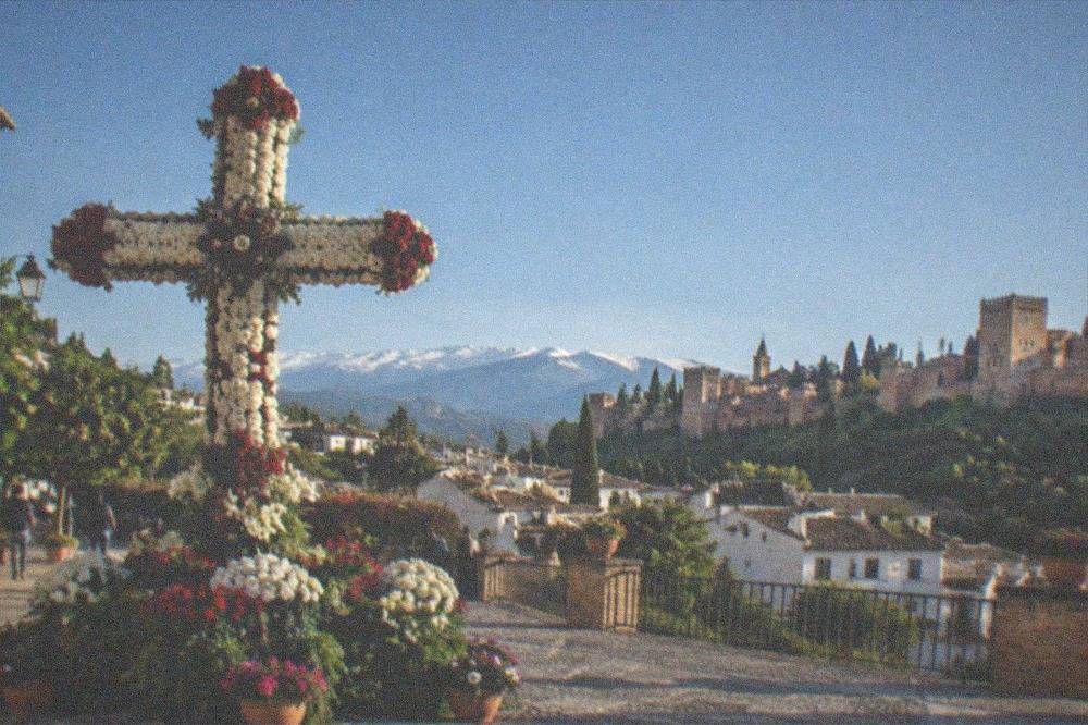 A decorated flower cross in a Granada square during the May crosses festival