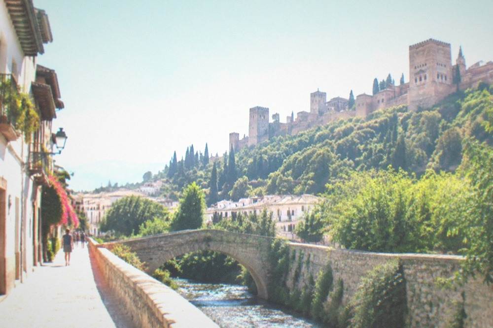 The Carrera del Darro riverside street with the Alhambra towers above it