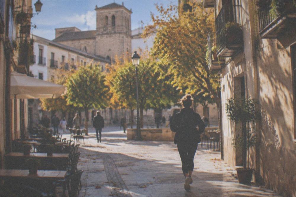 Empty plaza in Granada old town in late autumn with orange trees and mild light