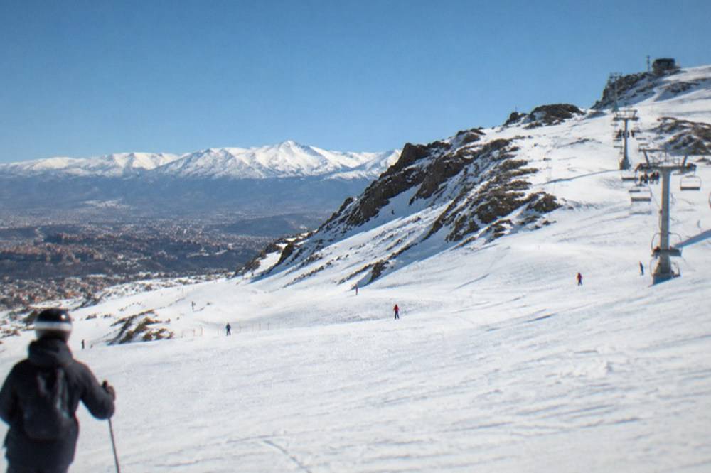 The Sierra Nevada mountains with snow visible above the rooftops of Granada in winter light