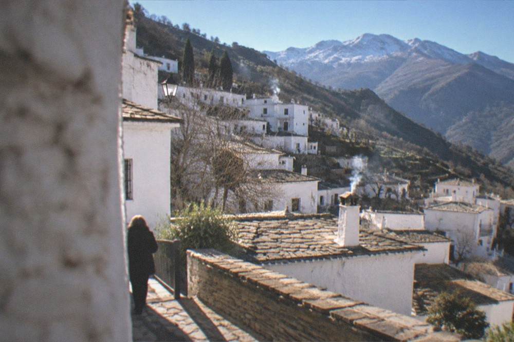White mountain villages terraced on a green hillside in the Alpujarras