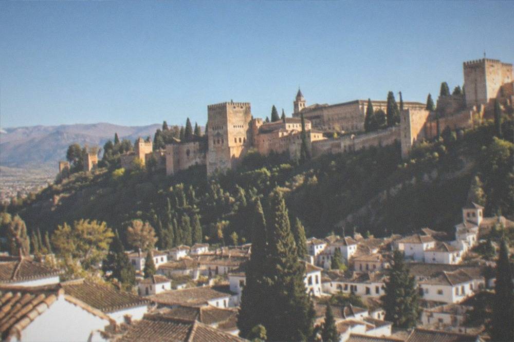A panoramic view over Granada's rooftops with the Alhambra on the opposite hillside