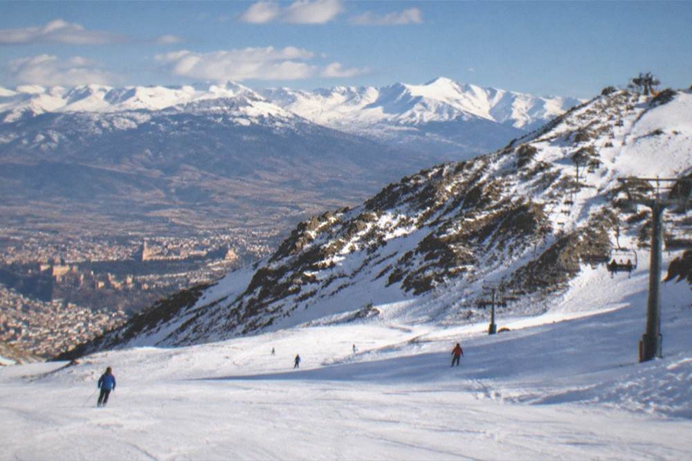 Snow-capped Sierra Nevada peaks rising behind the city of Granada in winter light