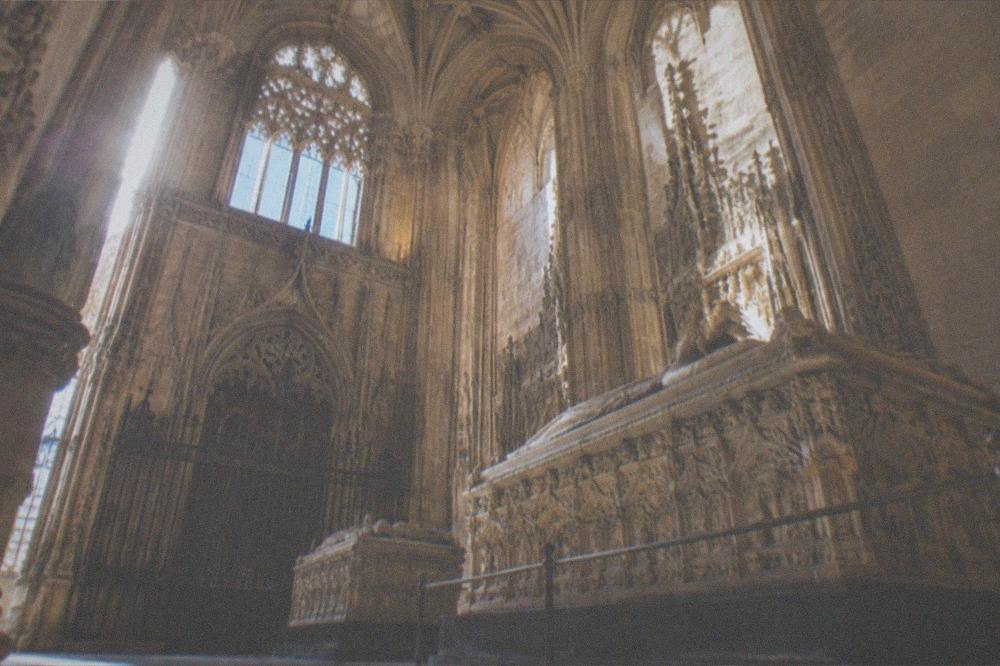 The ornate gothic interior of the Royal Chapel in Granada with royal tombs
