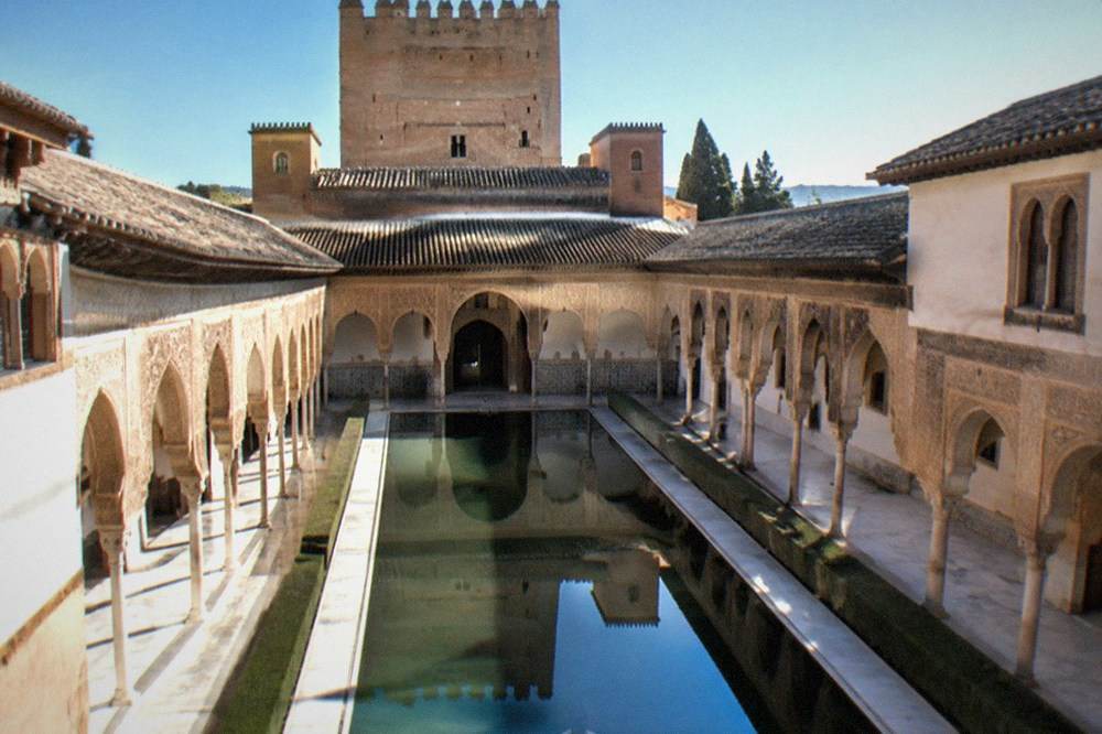 The ornate courtyard and reflecting pool of a Nasrid palace inside the Alhambra