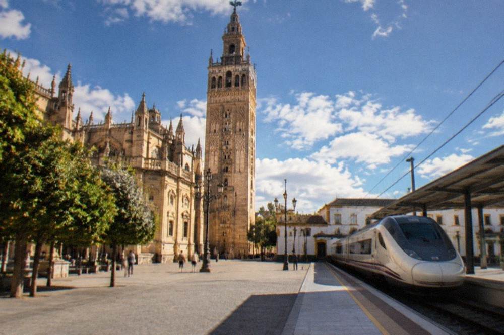 A high-speed train waiting at a platform in a Spanish railway station