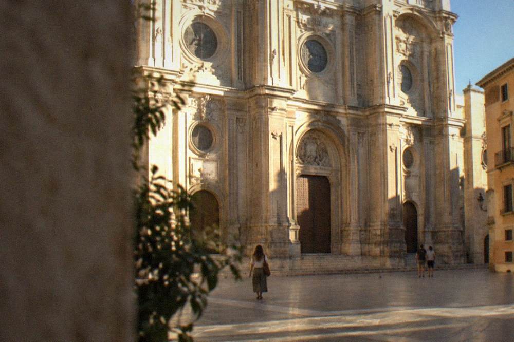 The ornate baroque facade of Granada Cathedral seen from the square outside